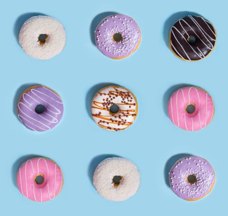 Nine colourful donuts on a blue background